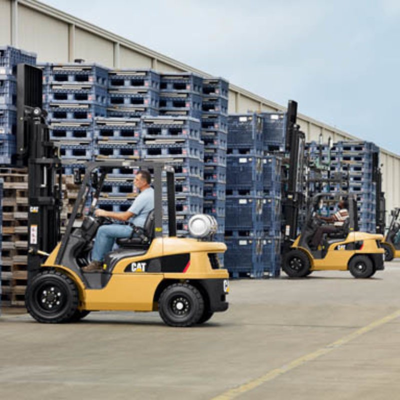 Two Cat lift trucks outside