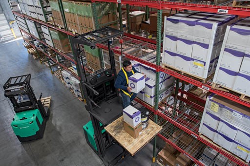 Two Mitsubishi Forklifts in Warehouse Aisle