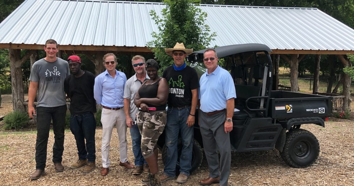 Group of people in front of a Cushman