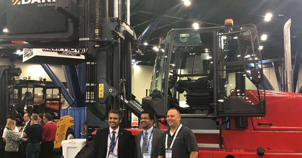 3 men standing in front of Kalmar forklift