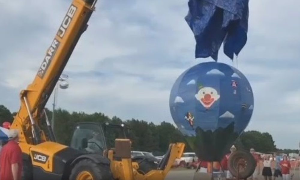 JCB equipment holding a balloon