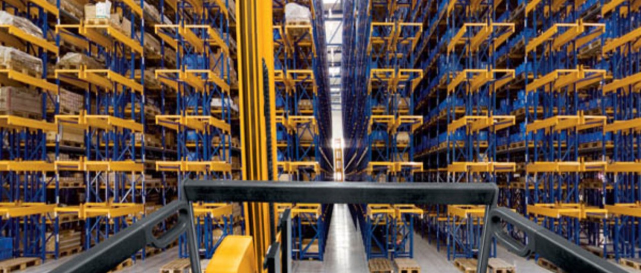 Turret truck driving through rows of pallet racking