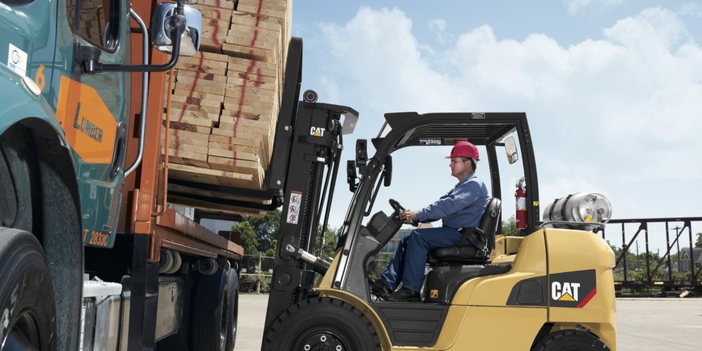 CAT Forklift unloading from a delivery truck