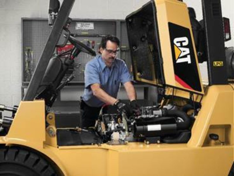 Service technician working on CAT forklift