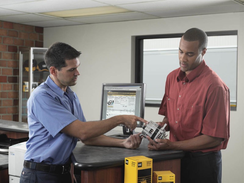 Two men at a material handling parts counter