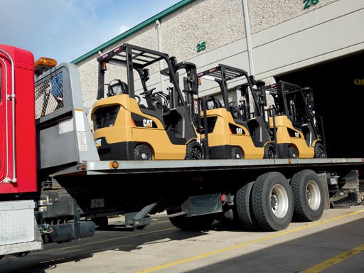 Cat forklifts on a delivery truck