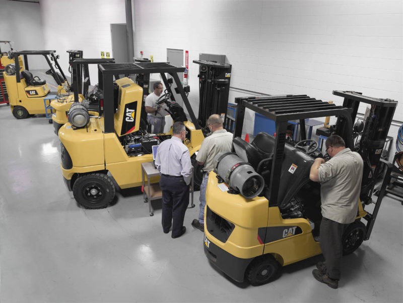 3 CAT forklifts in a service bay