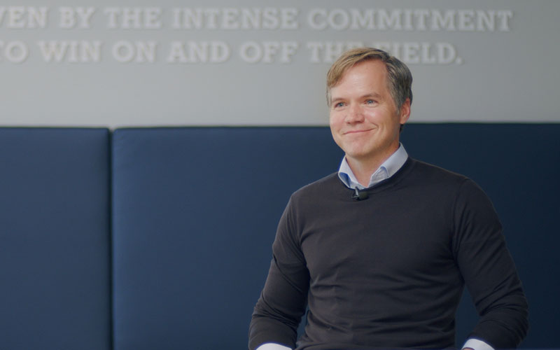 Robert Engstrom sitting in front of a wall with words